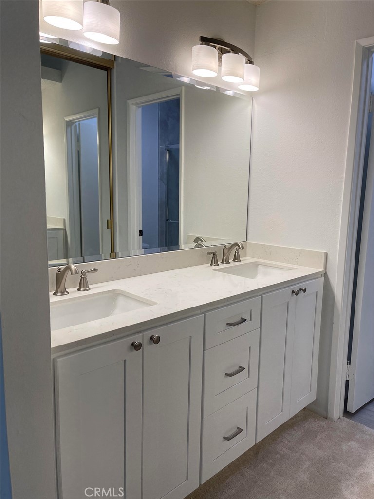 26445 Dunsmore, Unit 2 Lake Forest, CA 92630 - Photo 17 of 36 a bathroom with a double vanity sink and a mirror