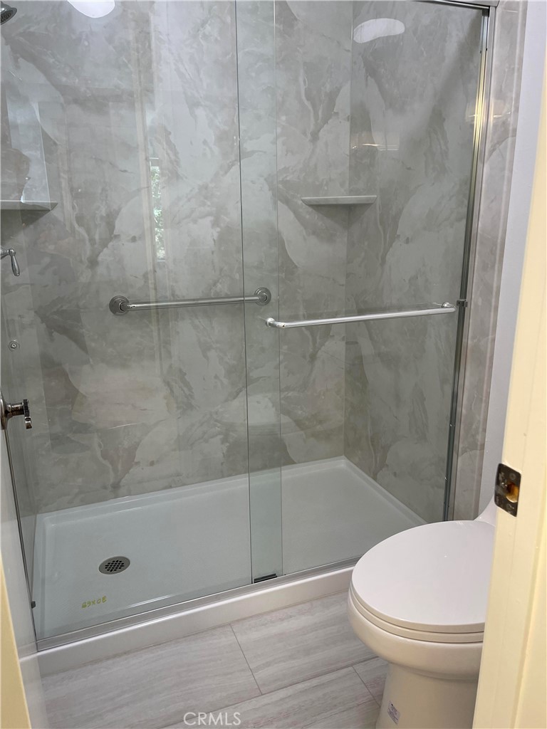 26445 Dunsmore, Unit 2 Lake Forest, CA 92630 - Photo 18 of 36 a bathroom with a shower and a toilet