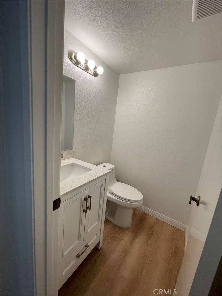 26445 Dunsmore, Unit 2 Lake Forest, CA 92630 - Photo 4 of 36 a bathroom with a toilet a sink and mirror