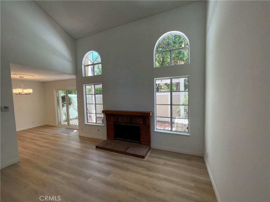 26445 Dunsmore, Unit 2 Lake Forest, CA 92630 - Photo 7 of 36 an empty room with windows and fireplace