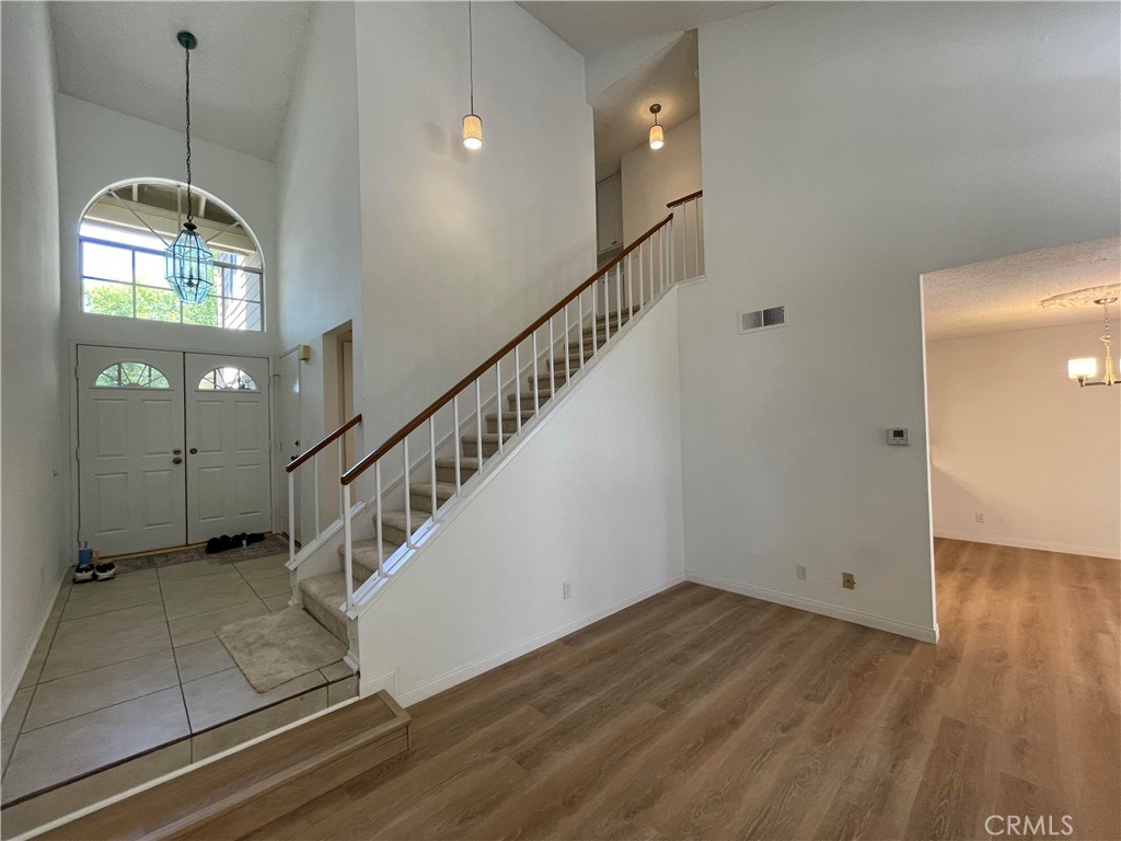 26445 Dunsmore, Unit 2 Lake Forest, CA 92630 - Photo 8 of 36 a view of a livingroom with wooden floor and stairs