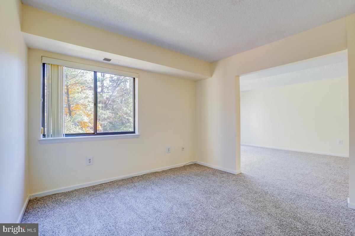 2921 North Leisure World Boulevard, Unit 1226 Silver Spring, MD 20906 - Photo 15 of 34 an empty room with windows