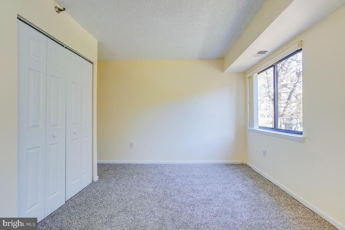 2921 North Leisure World Boulevard, Unit 1226 Silver Spring, MD 20906 - Photo 16 of 34 an empty room with windows