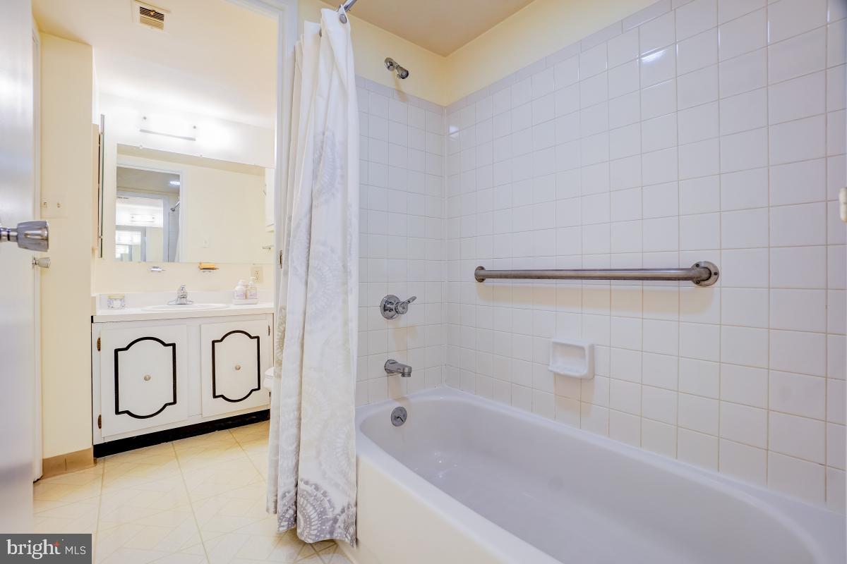 2921 North Leisure World Boulevard, Unit 1226 Silver Spring, MD 20906 - Photo 21 of 34 a bathroom with a bathtub and shower