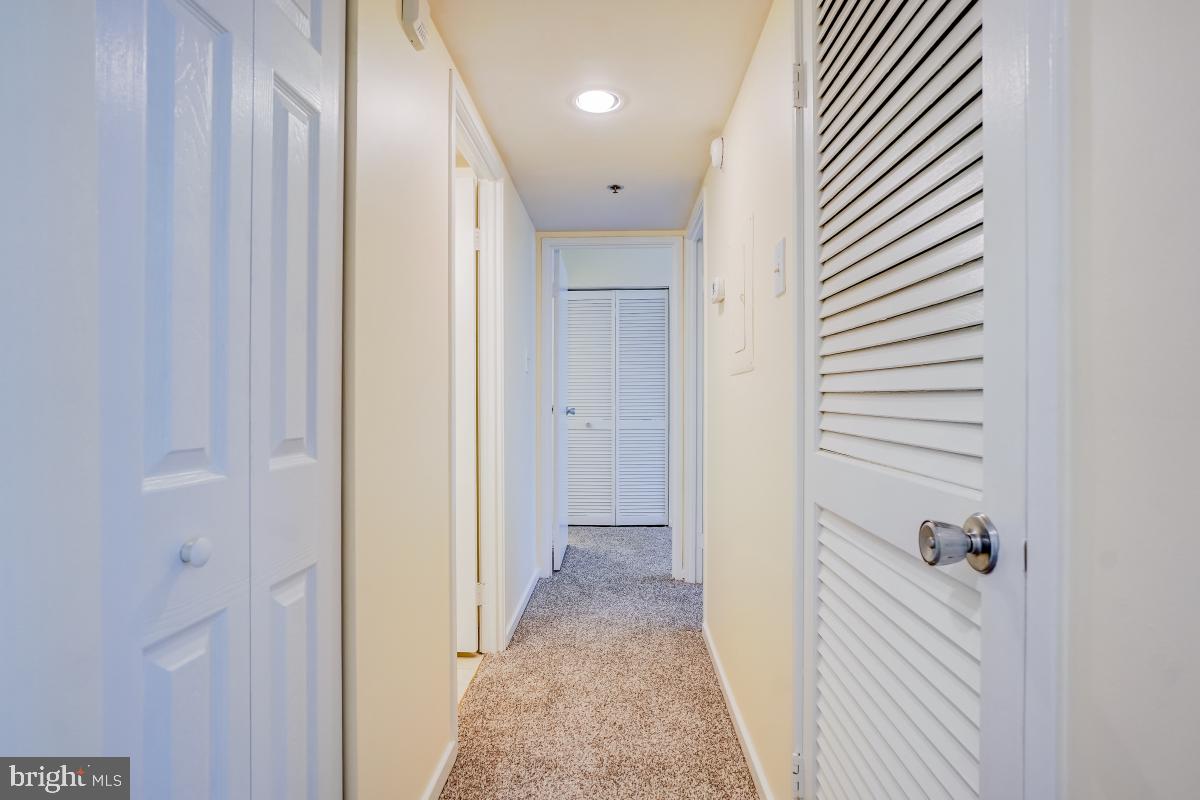 2921 North Leisure World Boulevard, Unit 1226 Silver Spring, MD 20906 - Photo 22 of 34 a view of a hallway with closet and a bathroom