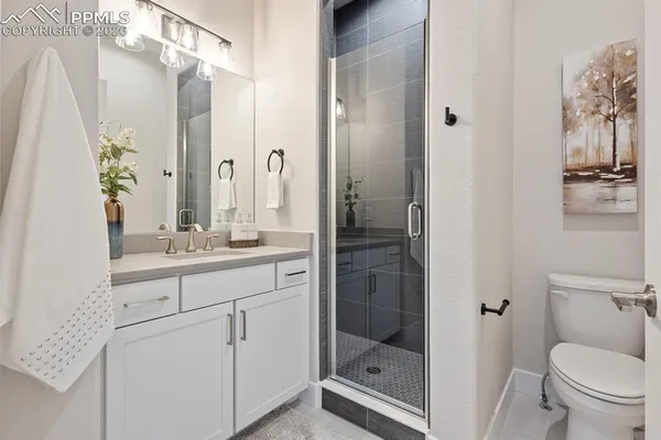 an empty room with a window and a ceiling fan