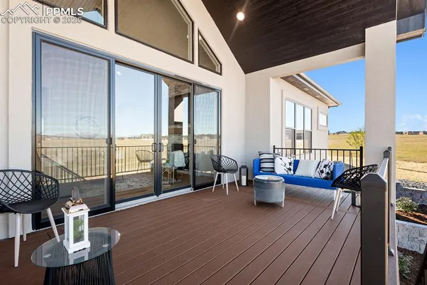a living room with furniture and floor to ceiling window
