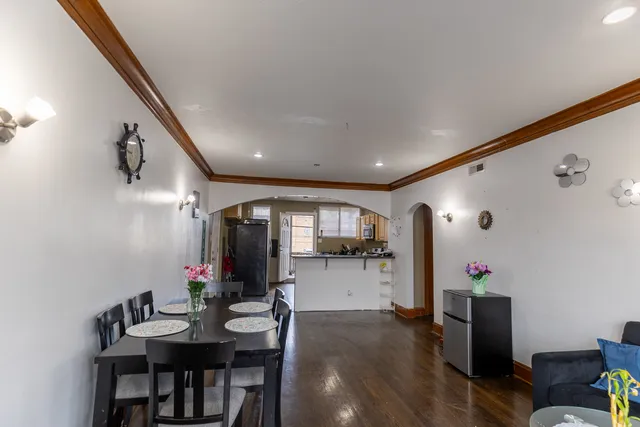 a view of a dining room with furniture and wooden floor