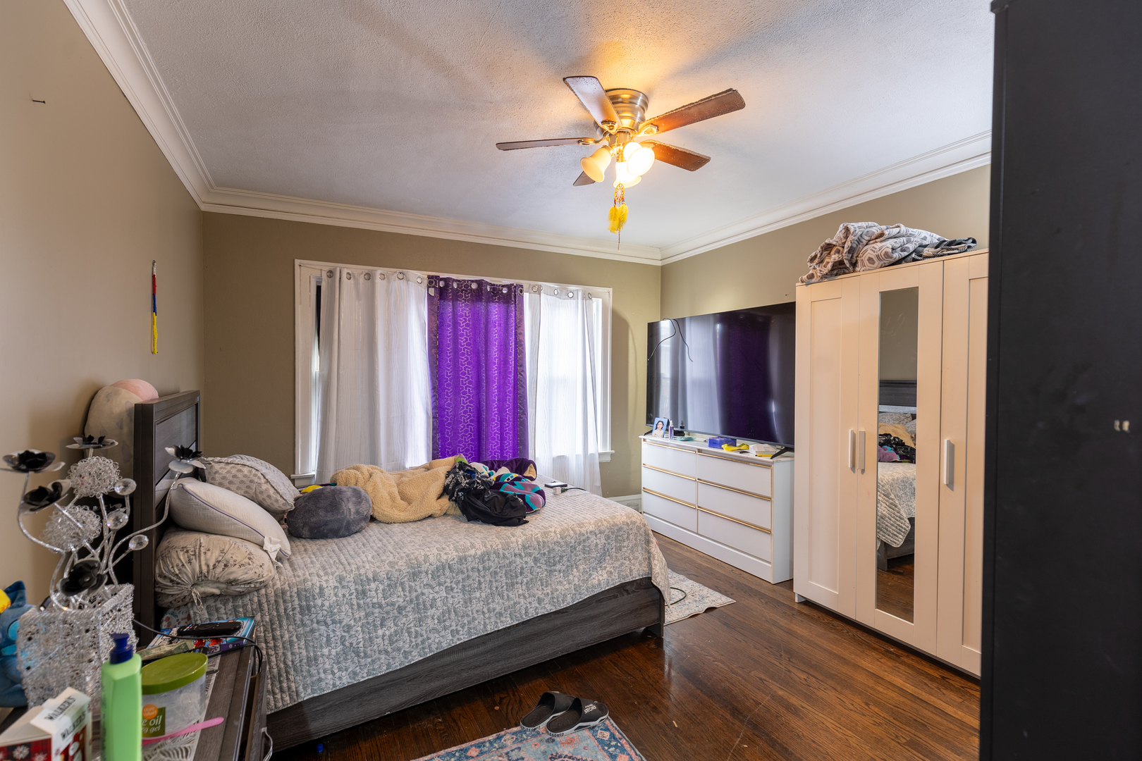 5820-24 West Roosevelt Road Chicago, IL 60644 - Photo 16 of 25 a bedroom with a bed and a chandelier