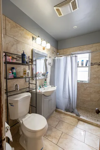 a bathroom with a toilet sink and shower