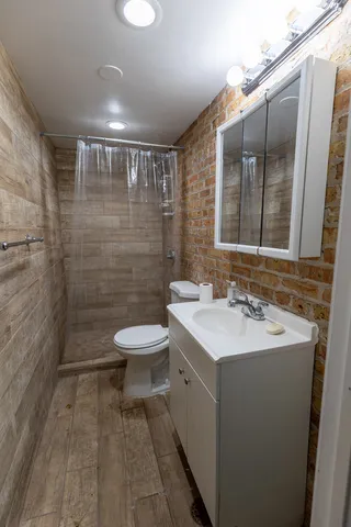 a bathroom with a sink toilet and shower