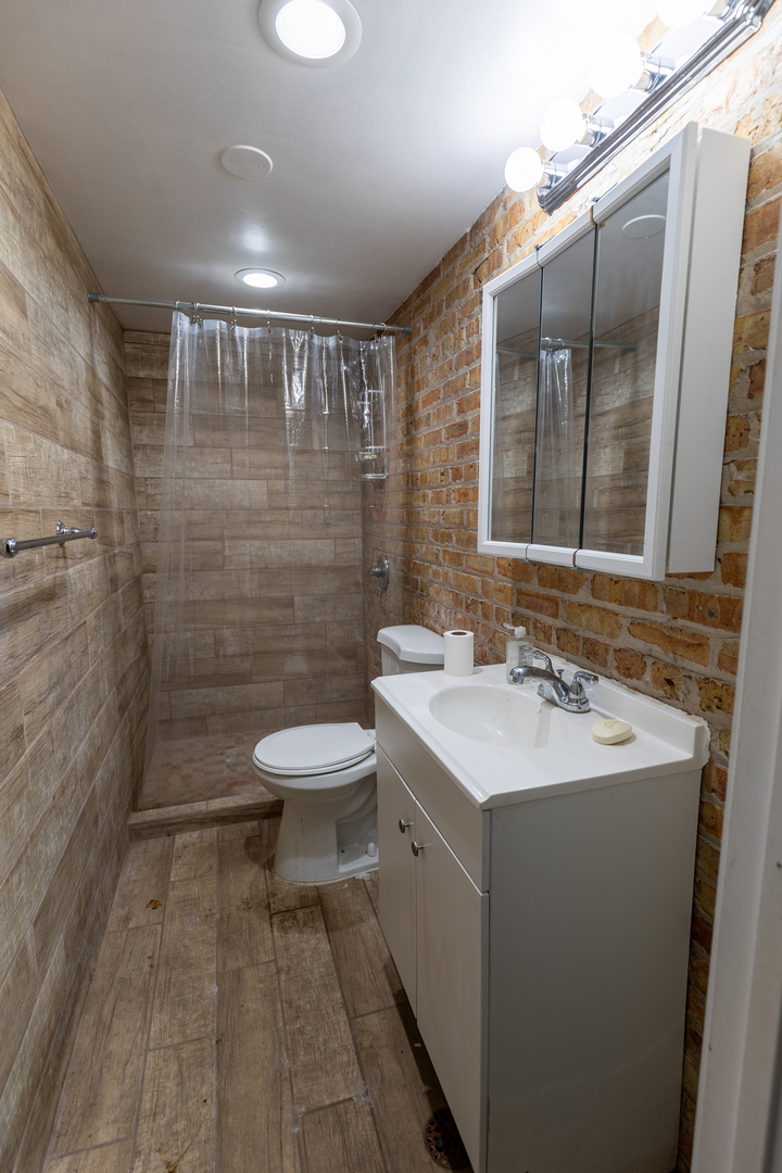 5820-24 West Roosevelt Road Chicago, IL 60644 - Photo 21 of 25 a bathroom with a sink toilet and shower