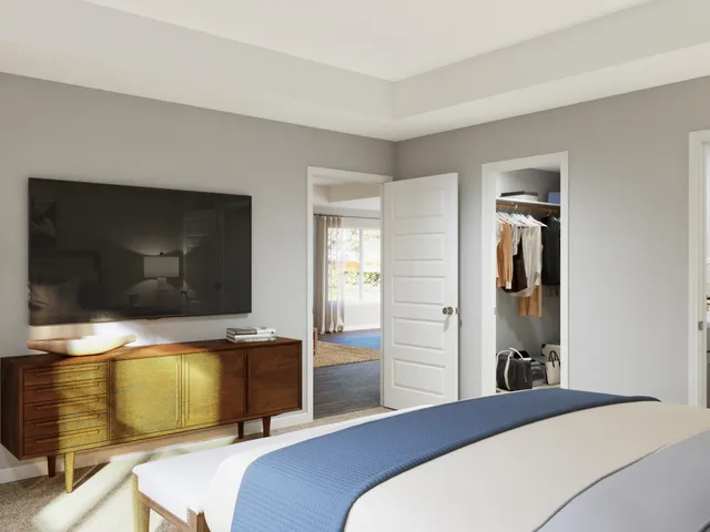 a bedroom with a large bed and a window