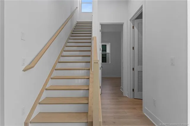 a view of an entryway with wooden floor