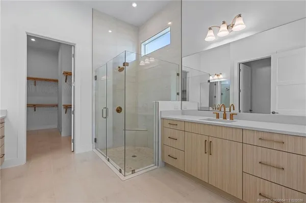 a bathroom with a double vanity sink shower and a mirror