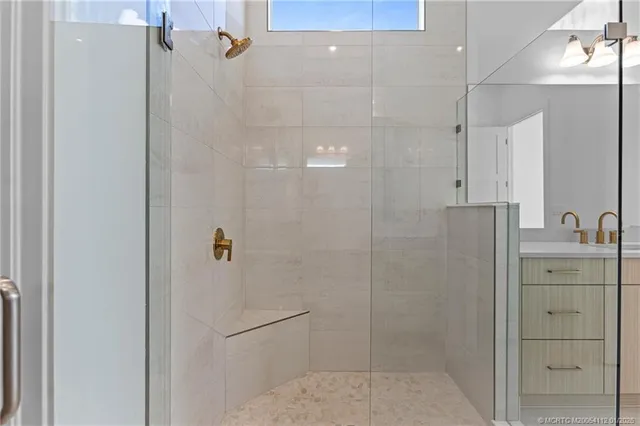 a bathroom with a shower and a sink