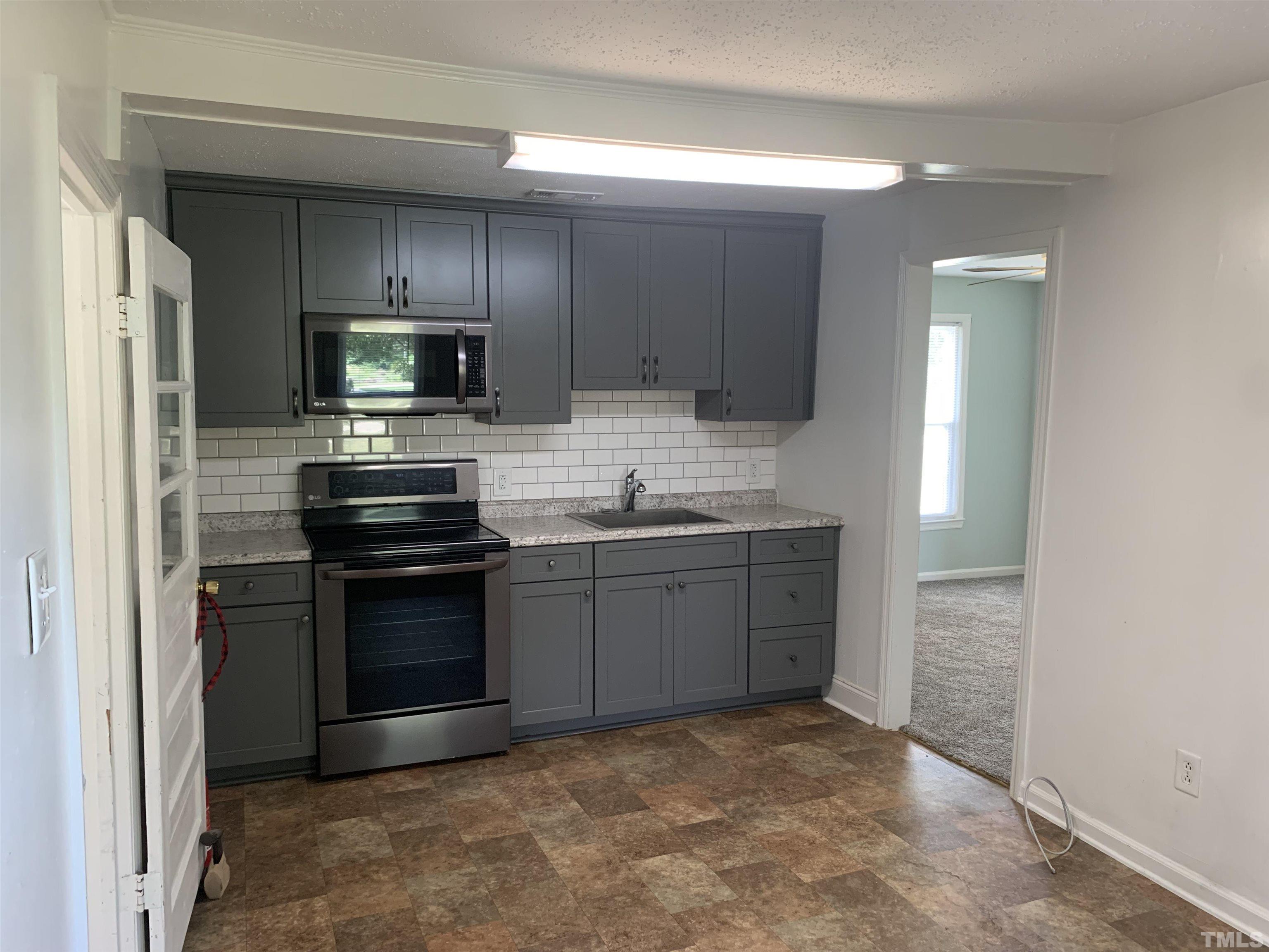 5272 Fairground Road Dunn, NC 28334 - Photo 23 of 24 a kitchen with a sink stove and refrigerator