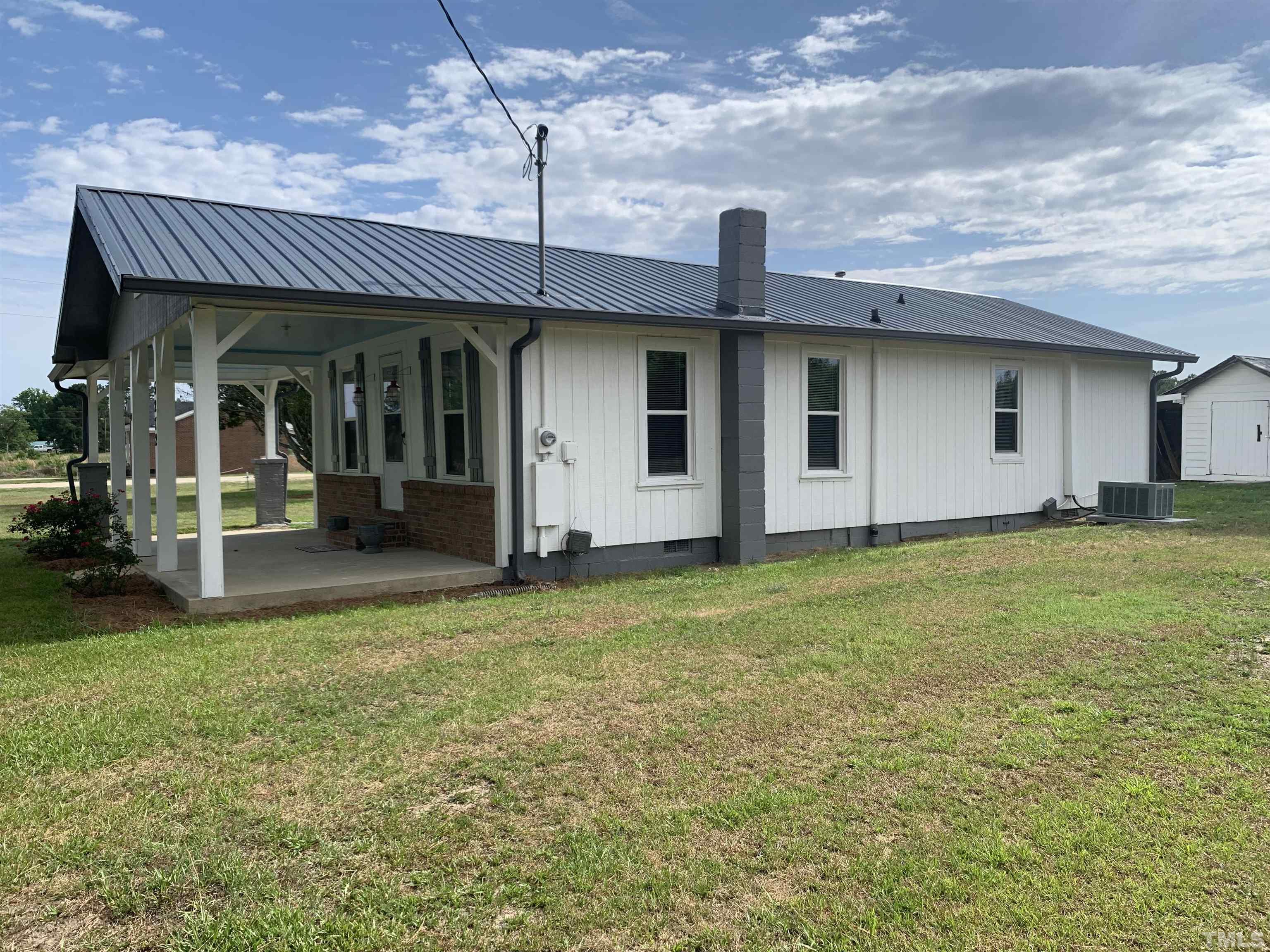 5272 Fairground Road Dunn, NC 28334 - Photo 6 of 24 a front view of a house with a garden