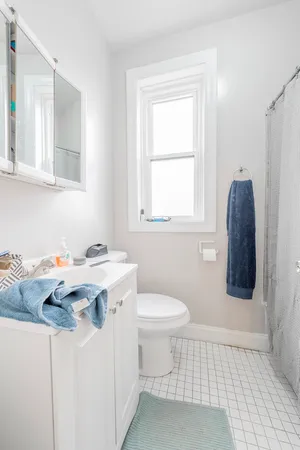 a bathroom with a sink toilet and mirror