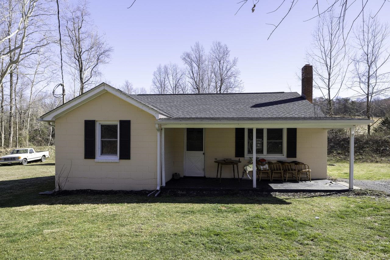 a view of a house with backyard porch and furniture