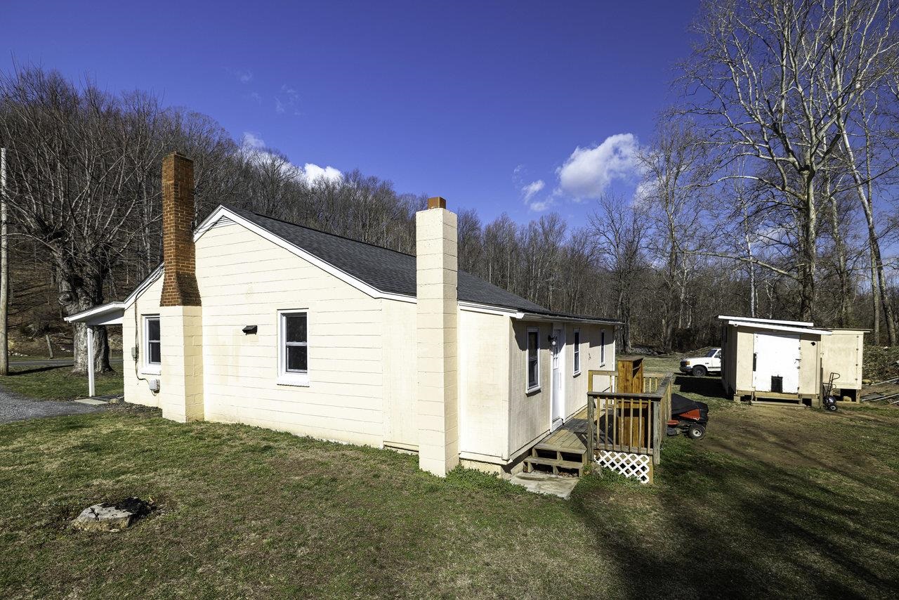2355 Pine Grove Road Stanley, VA 22851 - Photo 23 of 25 a view of a white house with a big yard and large trees