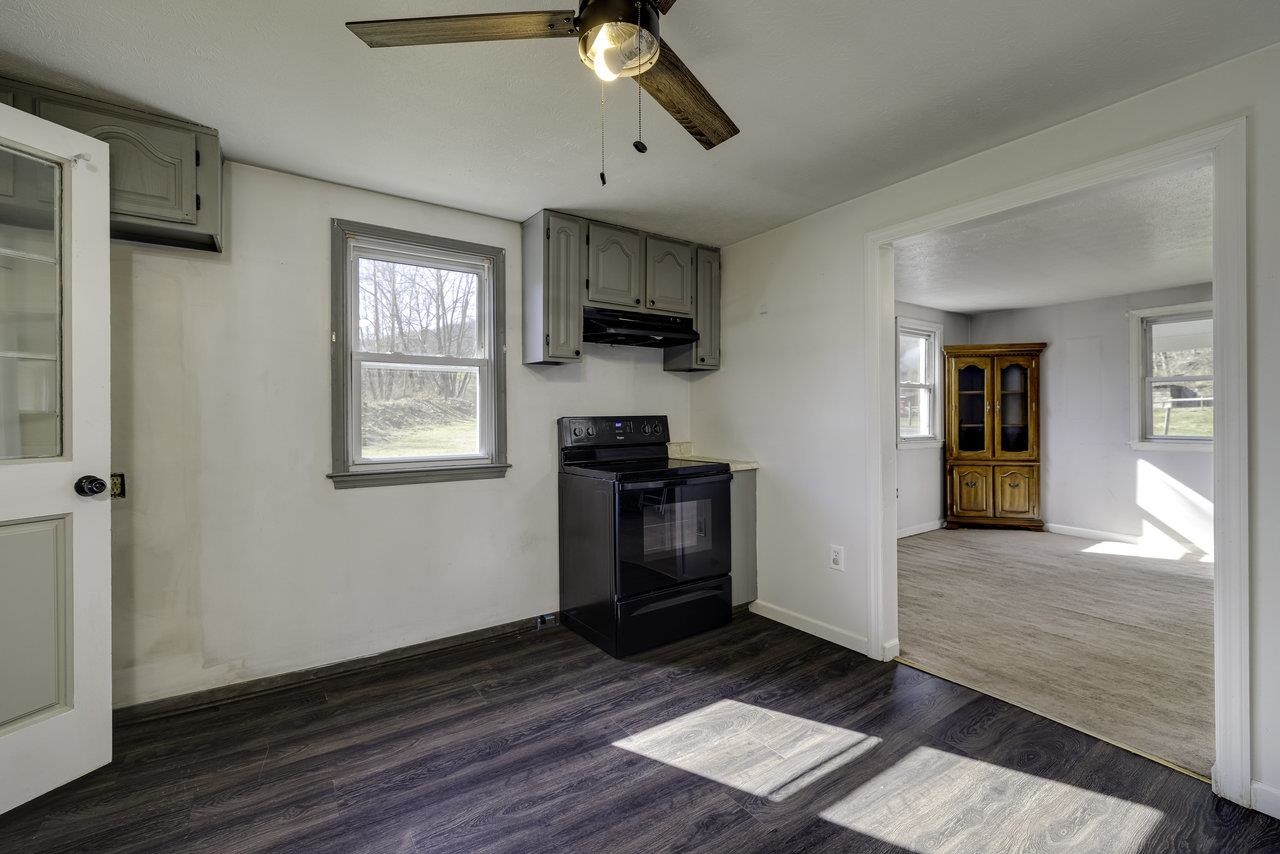2355 Pine Grove Road Stanley, VA 22851 - Photo 5 of 25 a kitchen with wooden floors and a fireplace