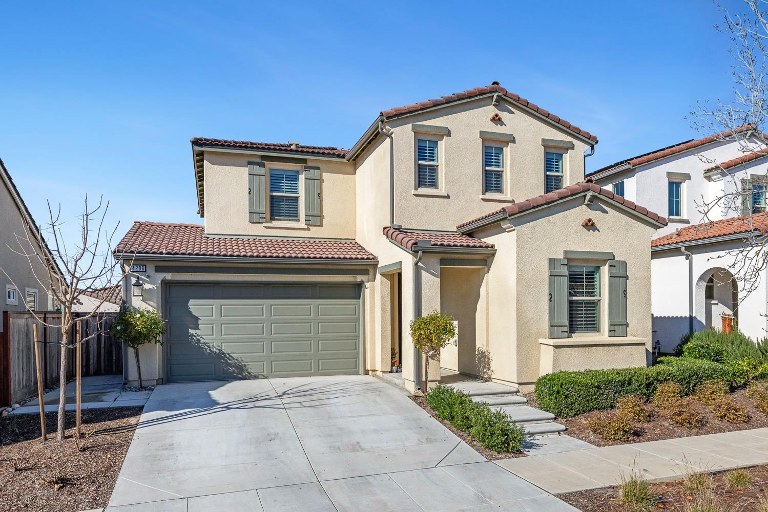 4286 Oak Knoll Road Madera, CA 93636 - Photo 1 of 43 a front view of a house with a yard and garage