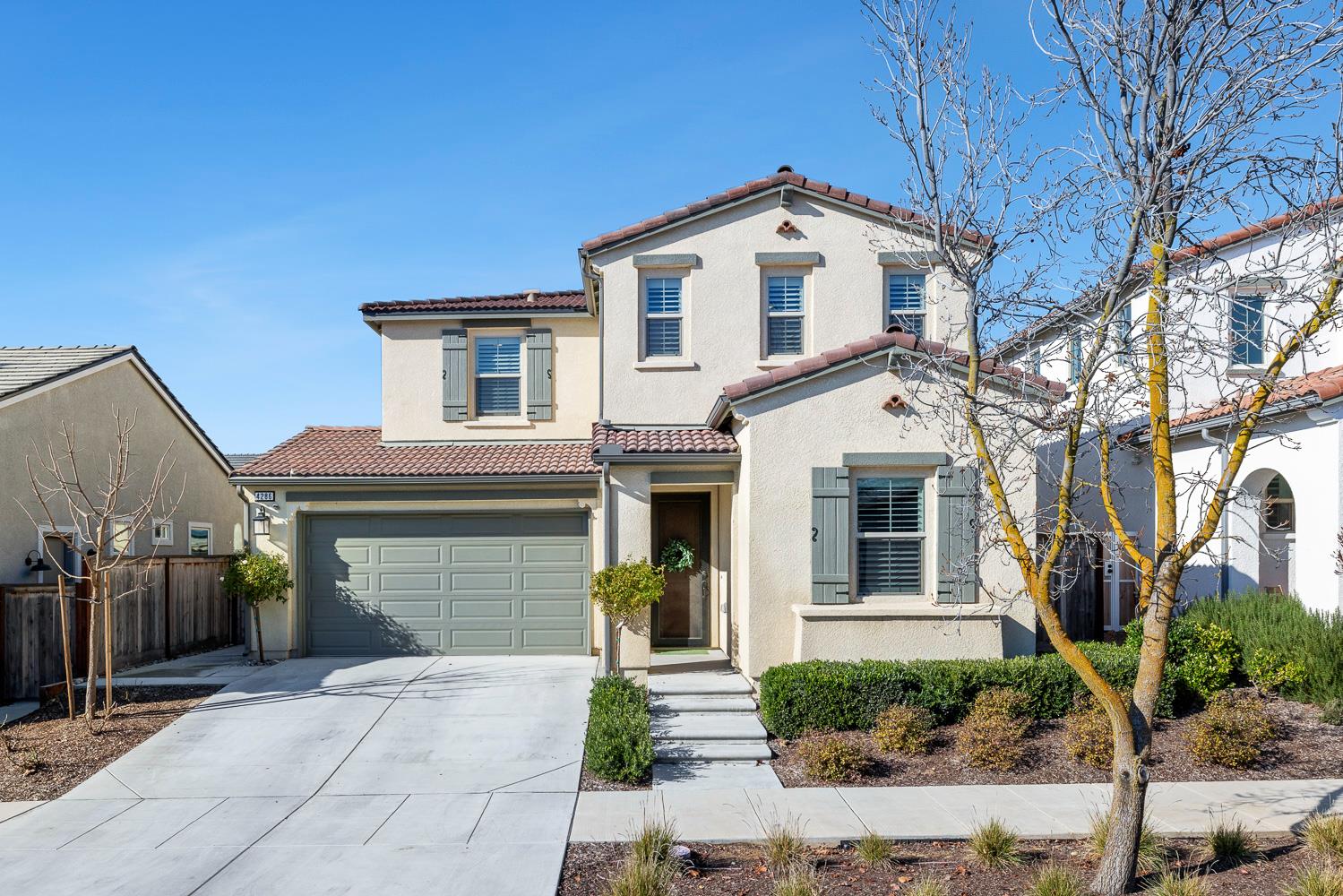 4286 Oak Knoll Road Madera, CA 93636 - Photo 2 of 43 a front view of a house with a yard and garage