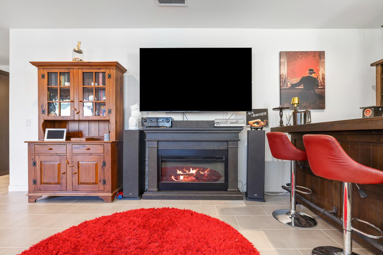 4286 Oak Knoll Road Madera, CA 93636 - Photo 23 of 43 a living room with furniture a flat screen tv and a fireplace