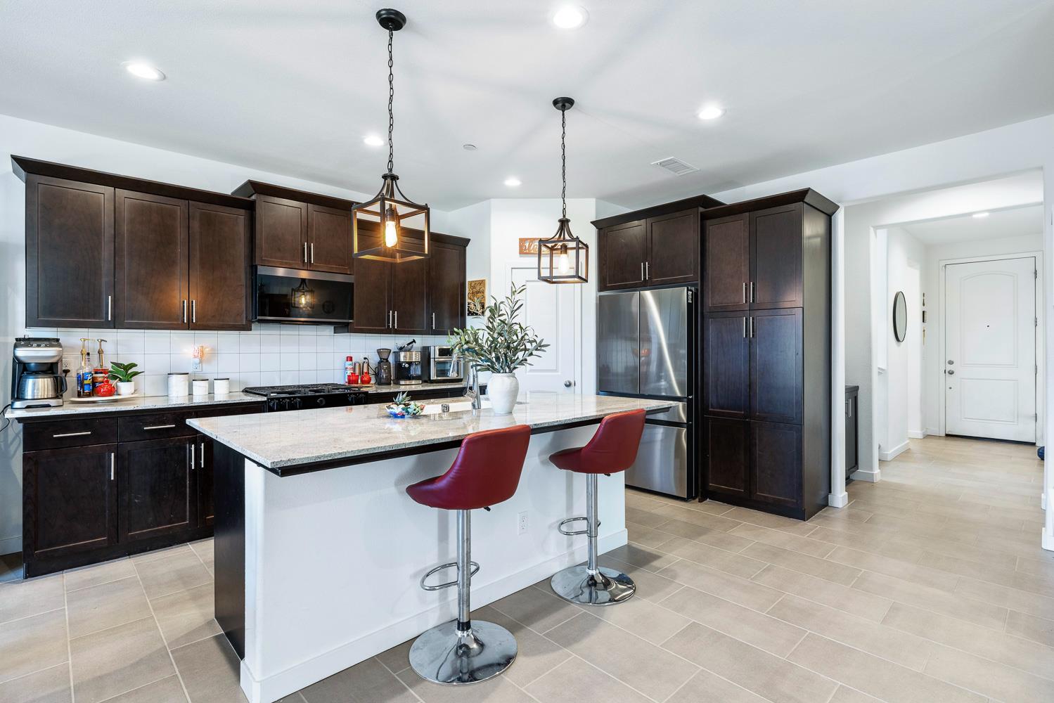 4286 Oak Knoll Road Madera, CA 93636 - Photo 25 of 43 a kitchen with stainless steel appliances granite countertop a sink refrigerator and microwave