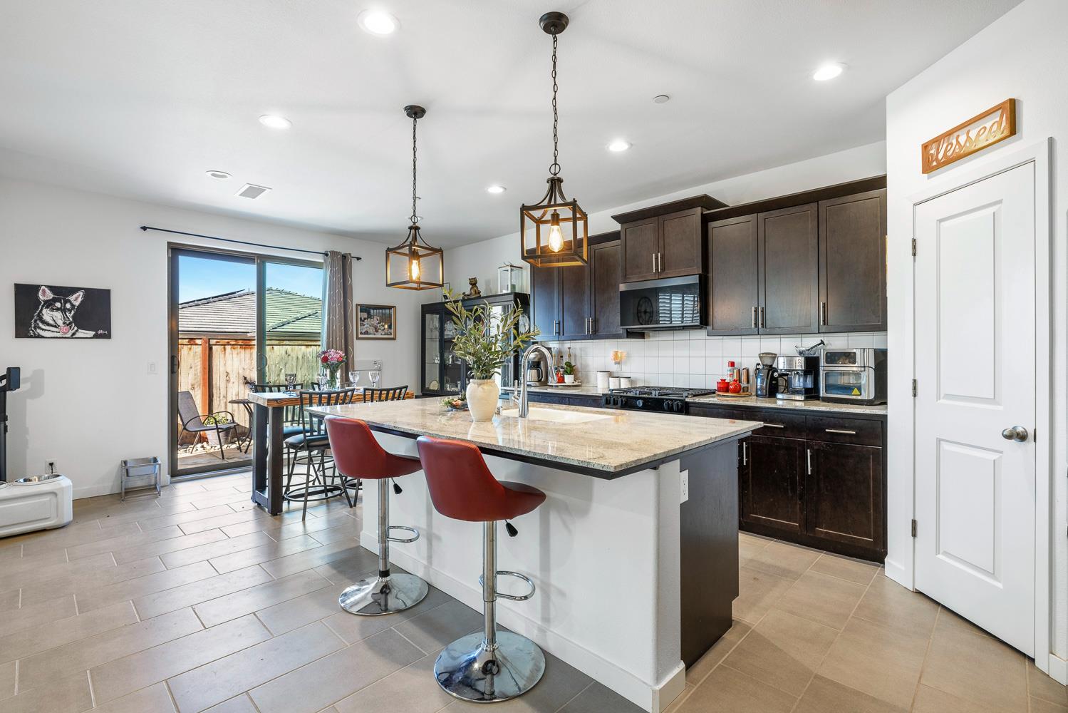 4286 Oak Knoll Road Madera, CA 93636 - Photo 26 of 43 a kitchen with granite countertop a sink and a refrigerator