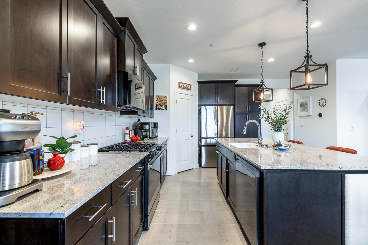 4286 Oak Knoll Road Madera, CA 93636 - Photo 28 of 43 a kitchen with granite countertop stainless steel appliances lots of counter space sink refrigerator and cabinets