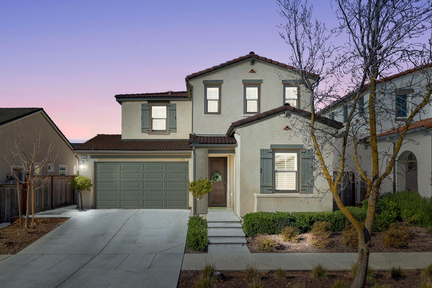 4286 Oak Knoll Road Madera, CA 93636 - Photo 3 of 43 a front view of a house with a yard and garage