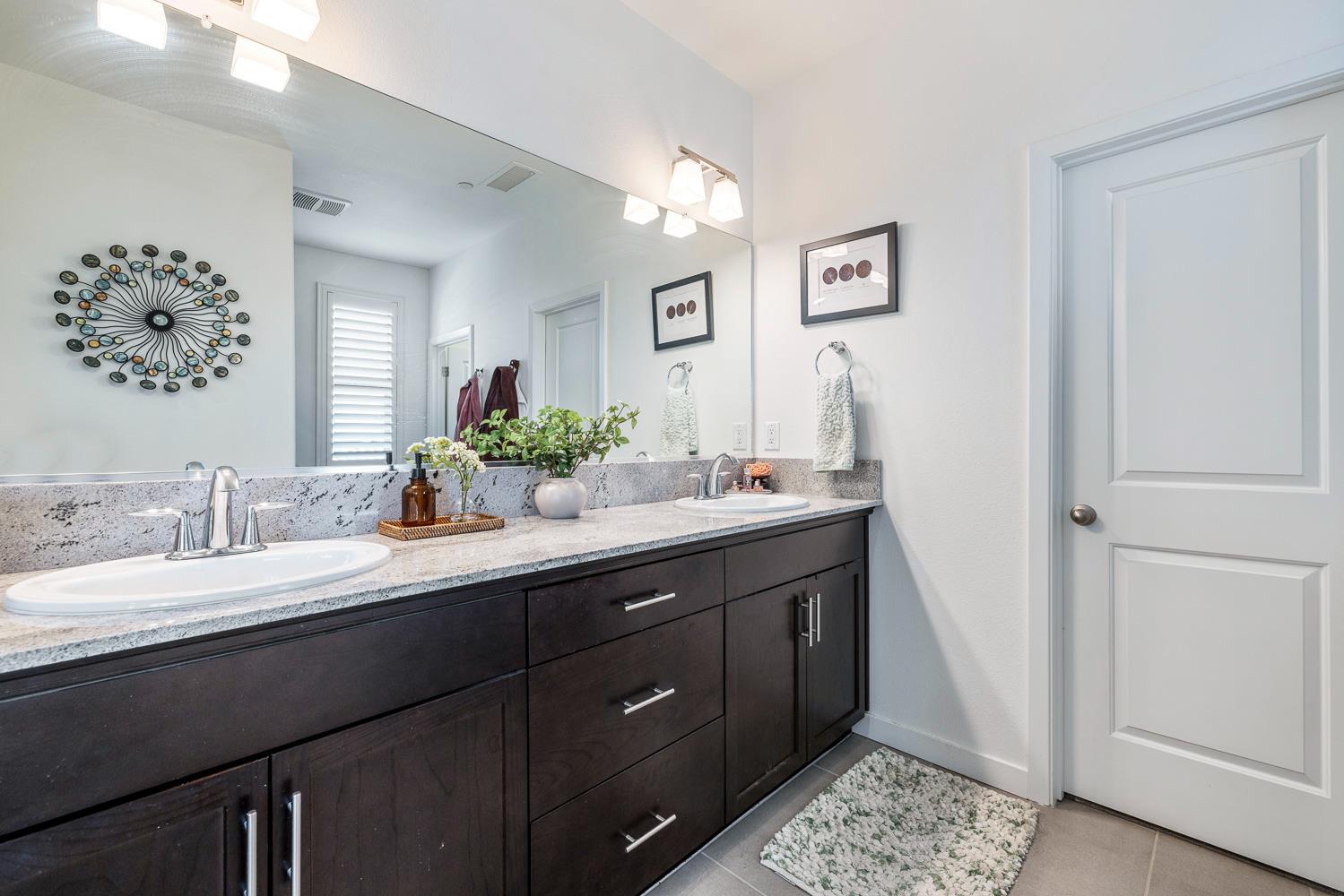 4286 Oak Knoll Road Madera, CA 93636 - Photo 37 of 43 a bathroom with a double vanity sink and a mirror