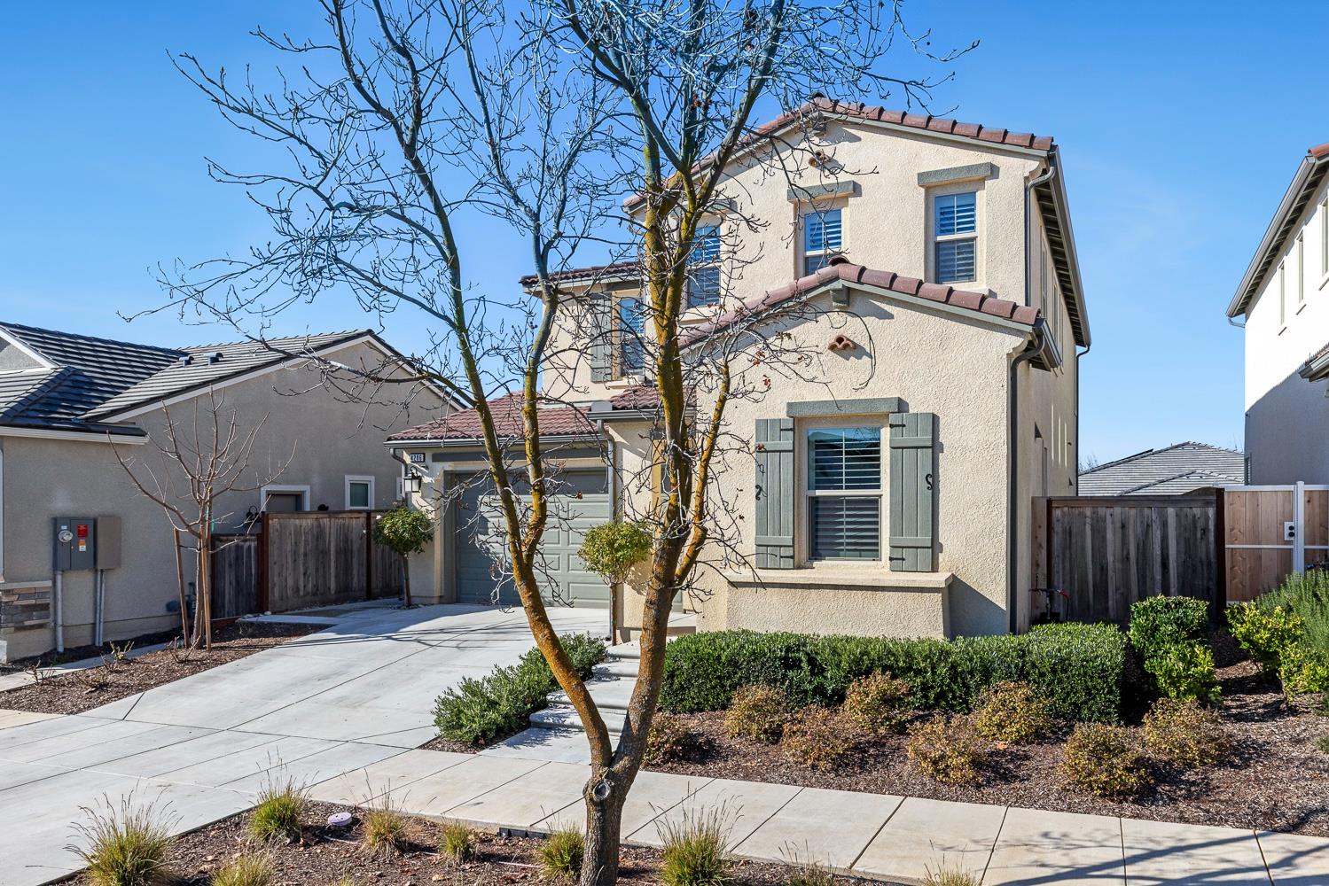 4286 Oak Knoll Road Madera, CA 93636 - Photo 4 of 43 a view of a white house with large windows and a small yard