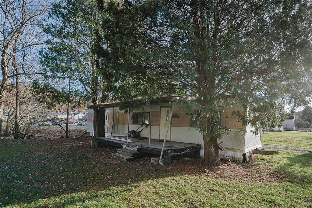 349 Adams Street Clymer, PA 15728 - Photo 28 of 36 a backyard of a house with barbeque oven and trees