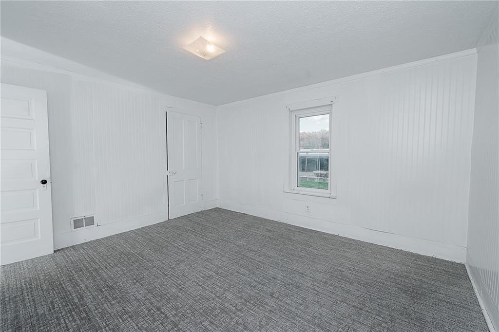 349 Adams Street Clymer, PA 15728 - Photo 33 of 36 a view of an empty room with wooden floor and a window