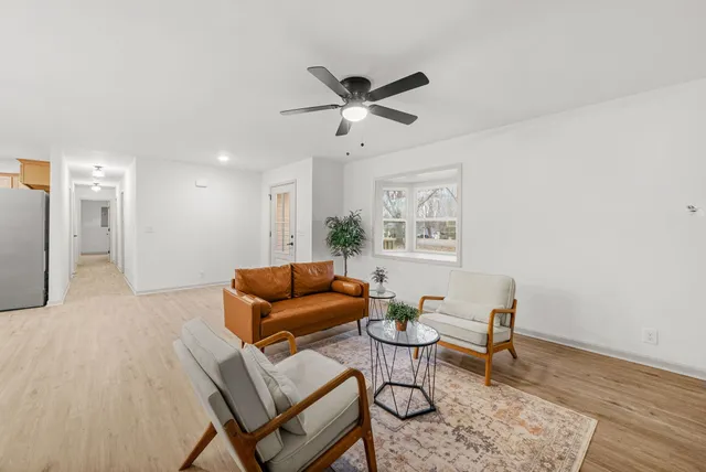 a living room with furniture and a wooden floor
