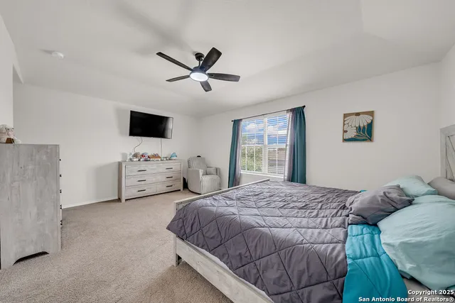 a spacious bedroom with a bed and a window