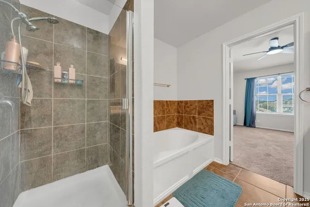 a bathroom with a bathtub and a shower