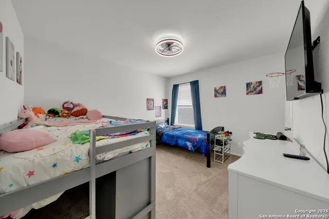 a bedroom with a bed and a tv