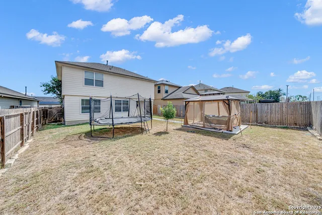 a view of a house with a yard and sitting area