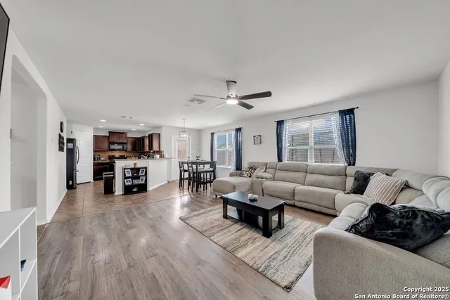 a living room with furniture and a large window