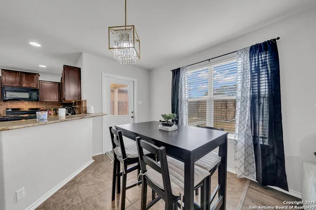 a kitchen with a table and chairs in it