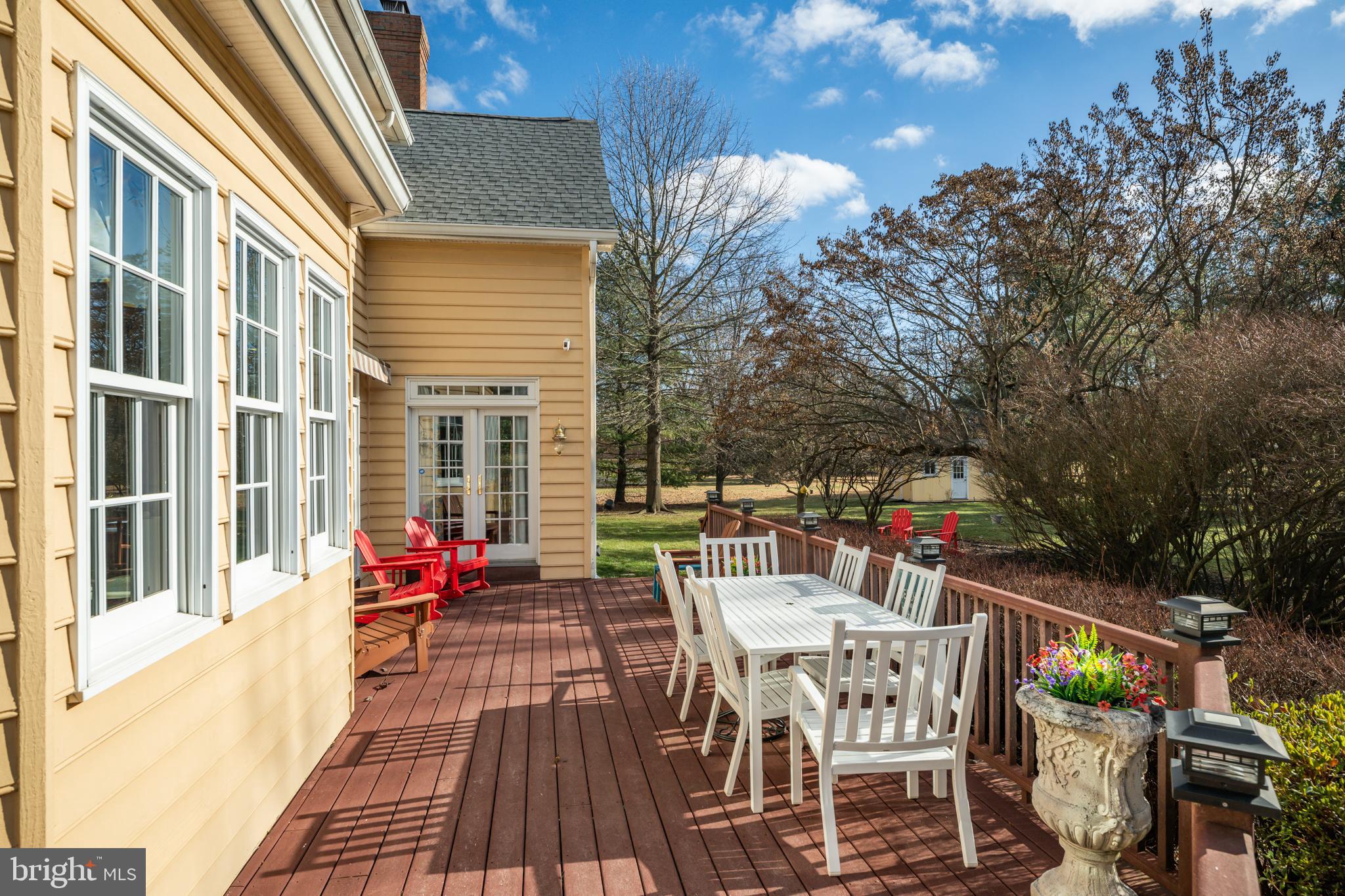 171 Firecreek Road Newtown, PA 18940 - Photo 24 of 54 a view of a patio with dining table and chairs with wooden floor and fence