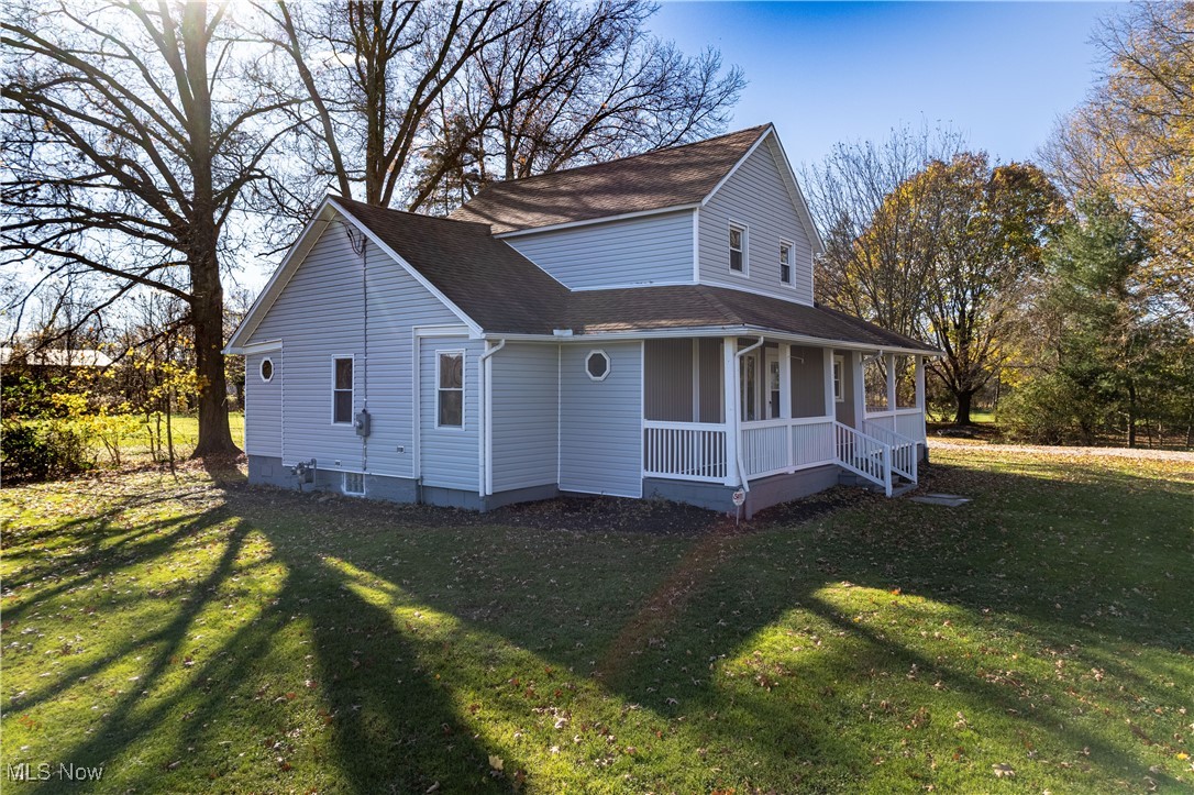1848 Wright Road Akron, OH 44320 - Photo 3 of 32 View of side/front with covered porch and a front lawn
