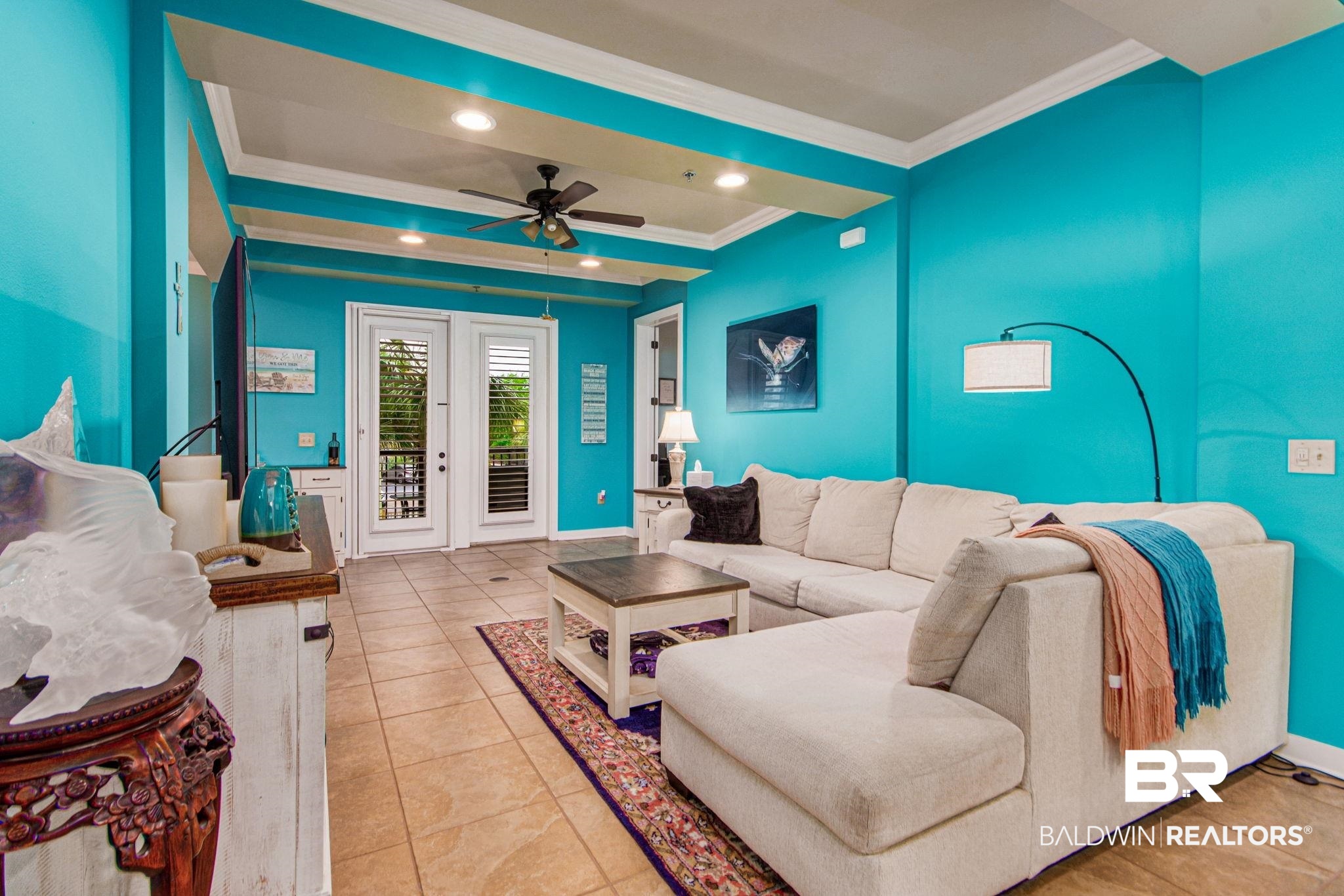 1430 Regency Road, Unit I201 Gulf Shores, AL 36542 - Photo 8 of 34 Living room featuring ceiling fan, ornamental molding, and light tile patterned floors