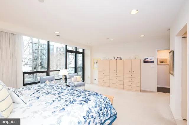 a spacious bedroom with a large bed and a large window