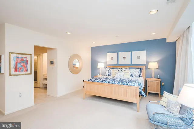 a bedroom with a bed and a lamp