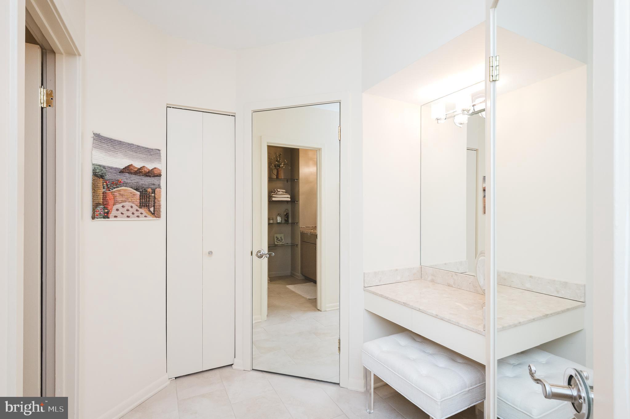 4001 Old Court Road, Unit 218 Baltimore, MD 21208 - Photo 17 of 44 a bathroom with a shower sink and mirror